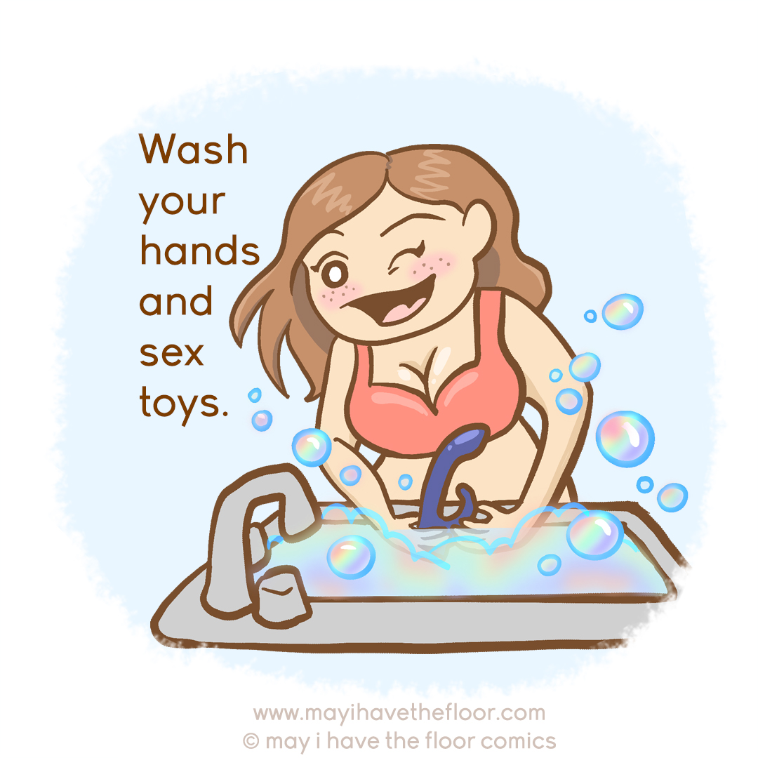 An image of a curvy brunette showing cleavage in a red bra. She is washing her hands and a rabbit vibrator in a sink. She has an open smile and is winking towards the viewer. Rainbow bubbles are coming out of the sink. The text reads, "Wash your hands and sex toys". 